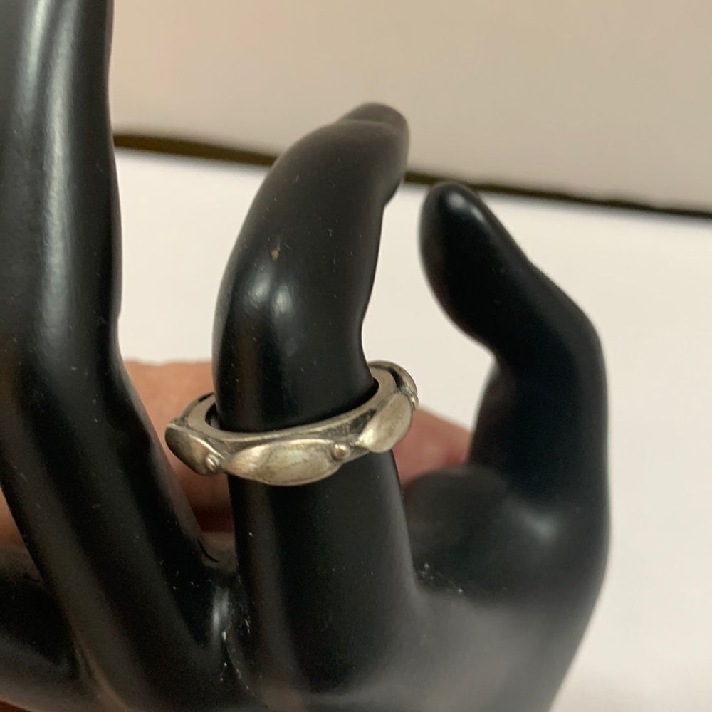 Size 7 silvertone ring with stamp “KC” inside.